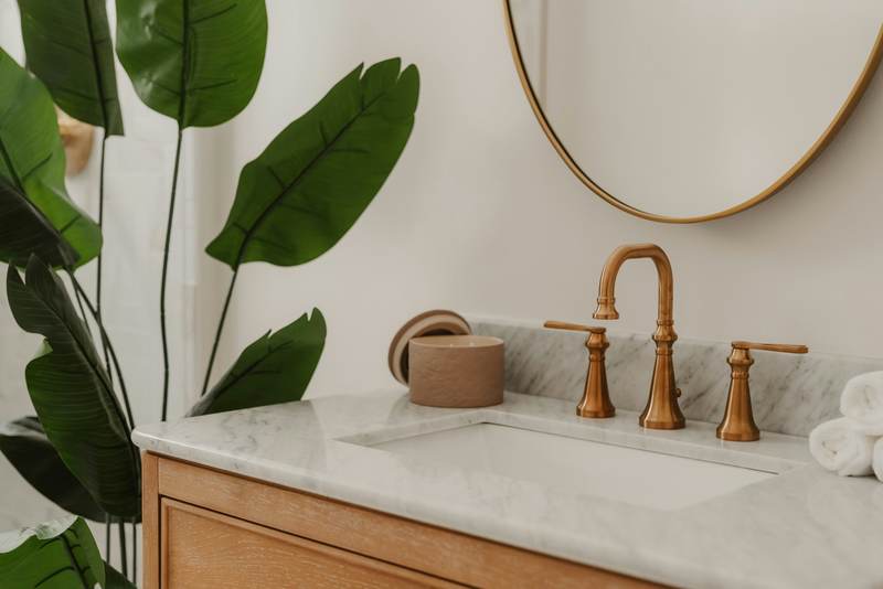 Marble bathroom vanity with a brushed brass faucet