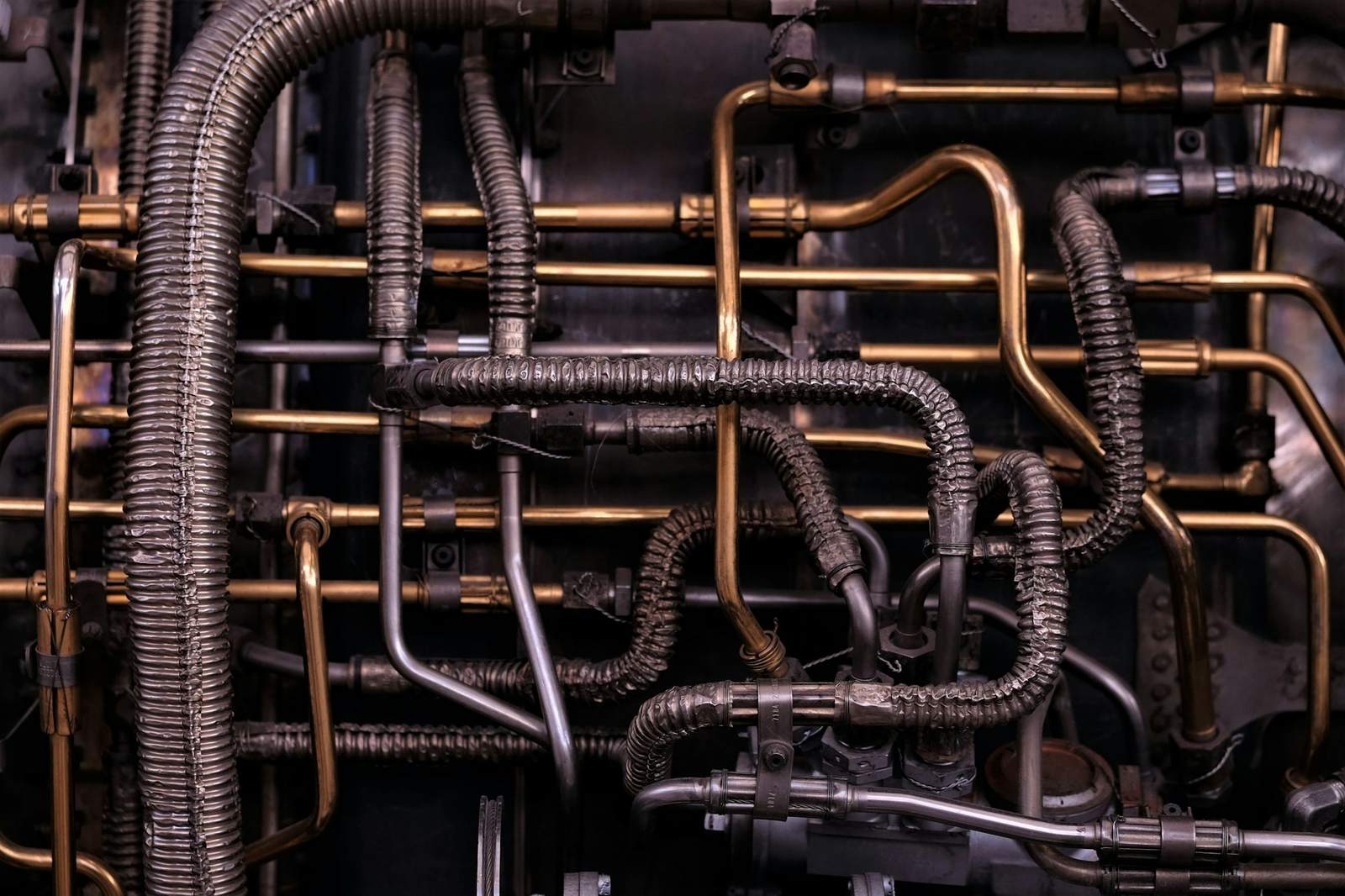 Close-up of brass and copper pipe runs in a mechanical room